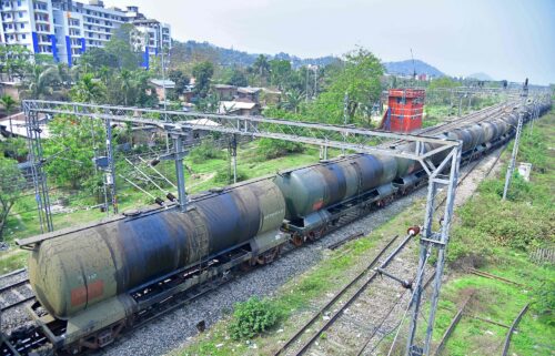 An oil tankers train passes near the Guwahati Refinery operated by Indian Oil Corporation.