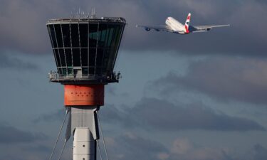 A British Airways Airbus A380 takes off in view of the control tower at Heathrow Airport