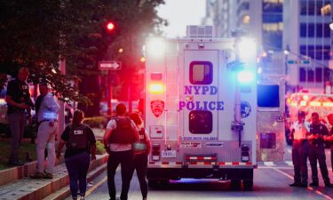 FBI agents investigate near a New York Police Department (NYPD) response vehicle near the scene of a reported shooter situation in Manhattan.