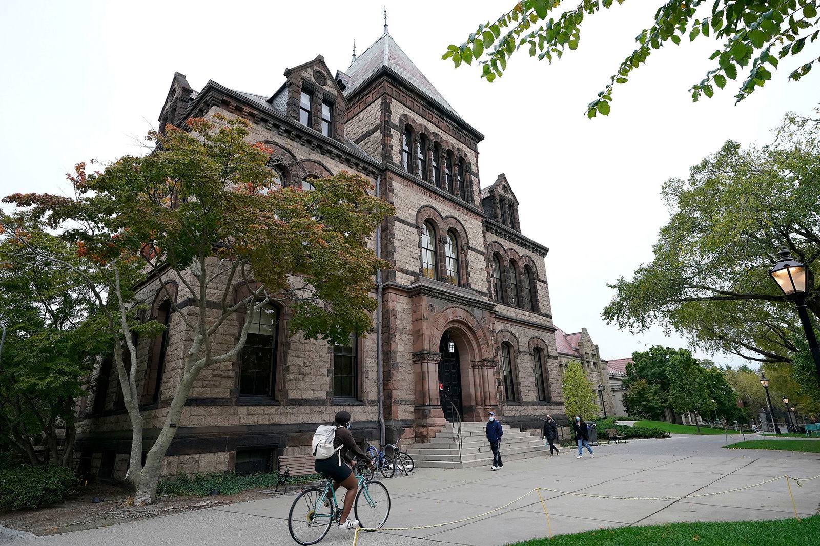 <i>Steven Senne/AP/File via CNN Newsource</i><br/>People travel through Brown University's campus in Providence