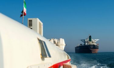 This 2018 photo shows a support vessel maneuvering a the crude oil tanker as it sails through the Persian Gulf to transport crude oil to export markets in Bandar Abbas
