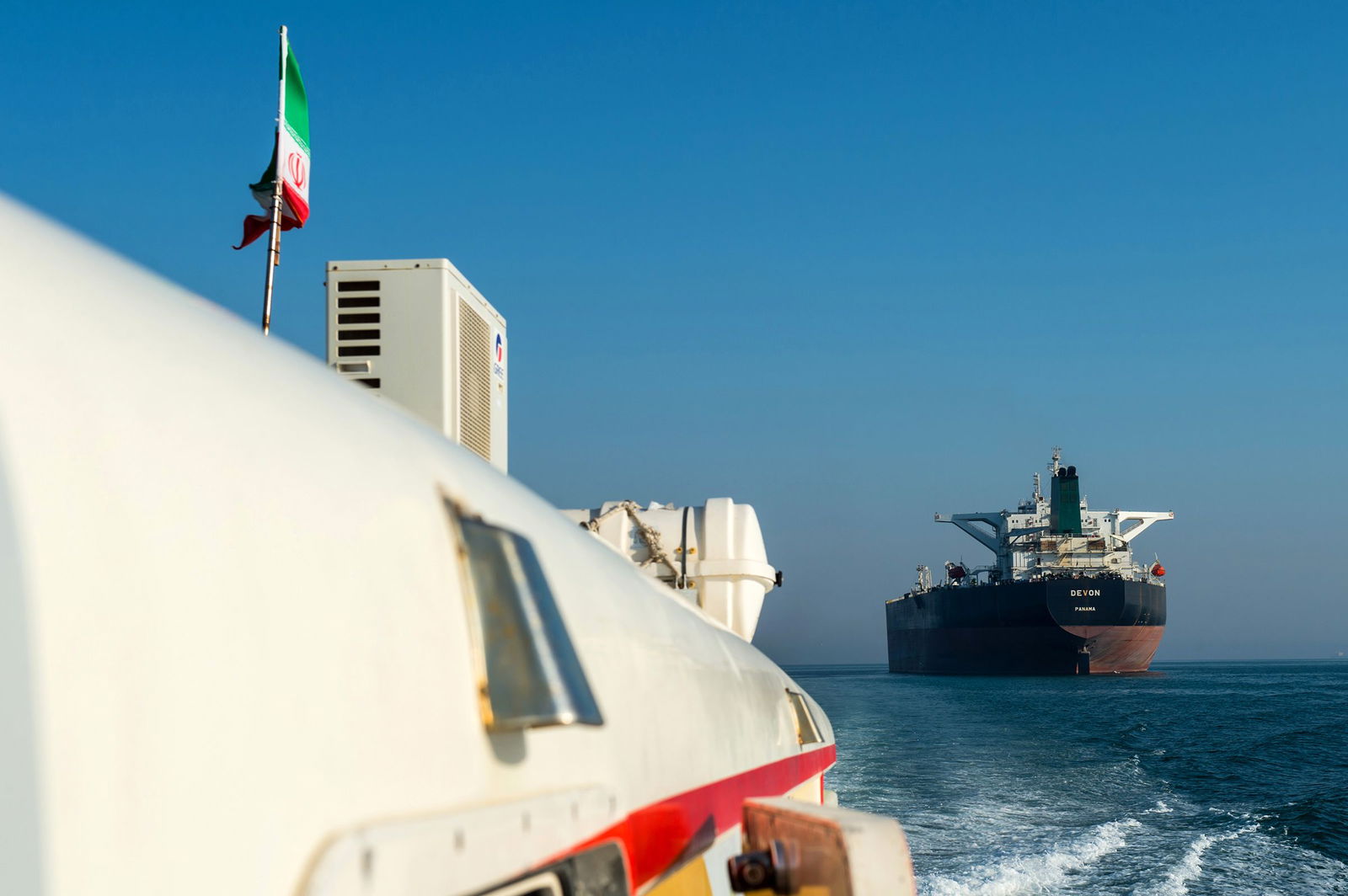 <i>Ali Mohammadi/Bloomberg/Getty Images via CNN Newsource</i><br/>This 2018 photo shows a support vessel maneuvering a the crude oil tanker as it sails through the Persian Gulf to transport crude oil to export markets in Bandar Abbas
