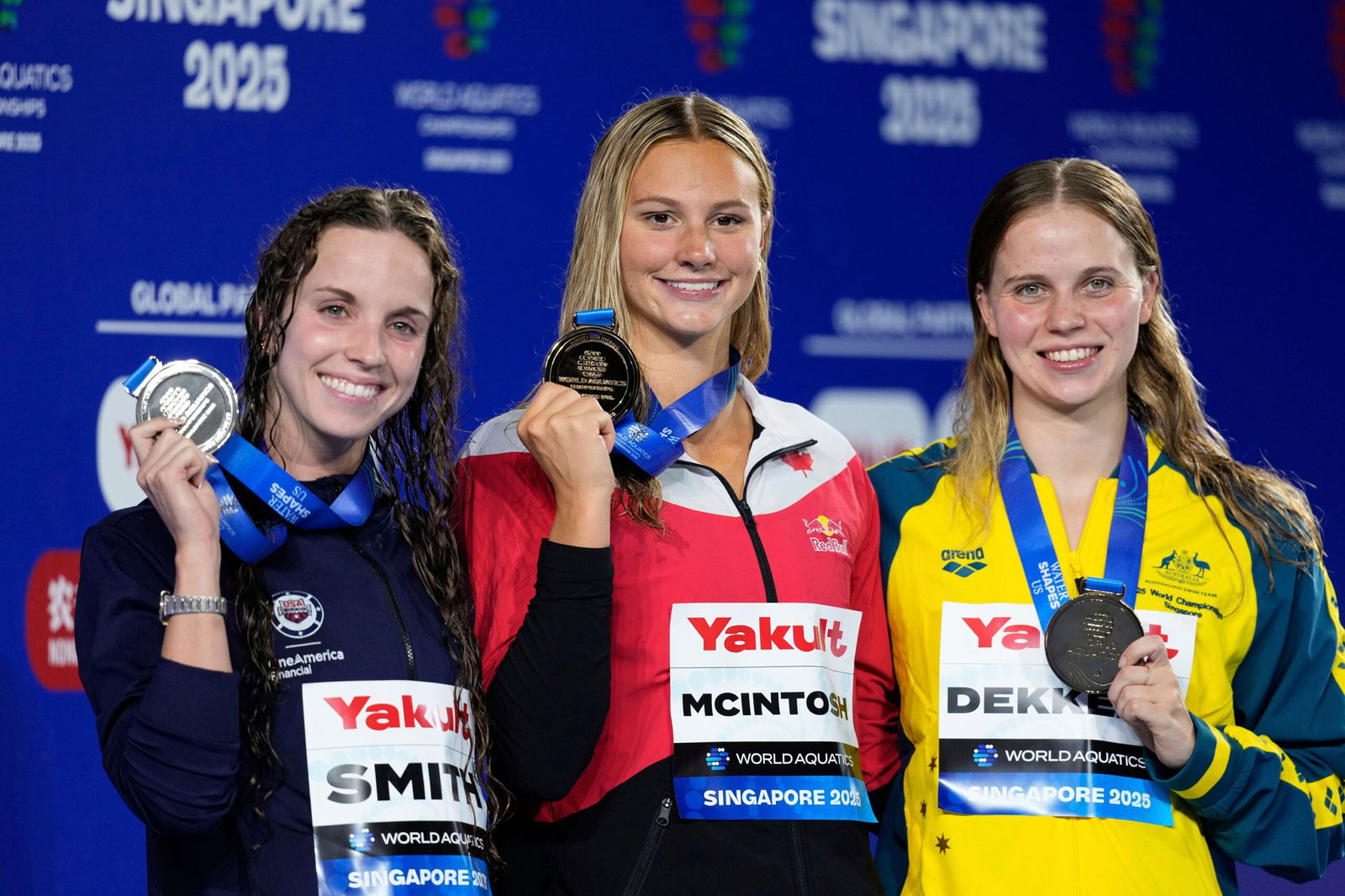 <i>Vincent Thian/AP via CNN Newsource</i><br/>McIntosh tops the podium alongside Smith and Dekkers.