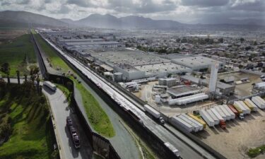 An aerial image shows trucks coming from Mexico enter the US to an inspection station after crossing the border in Otay Mesa