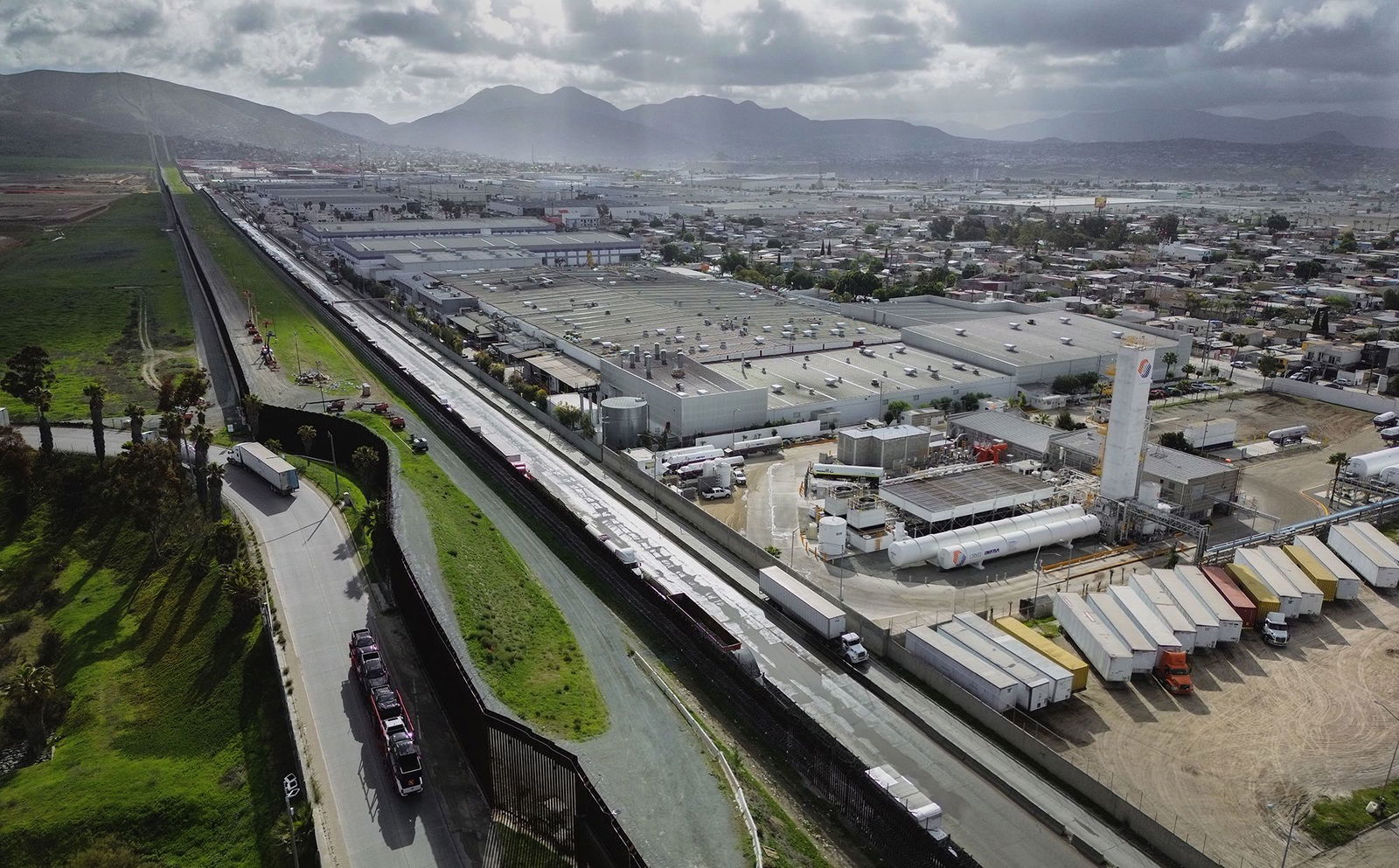<i>Sandy Huffaker/AFP/Getty Images via CNN Newsource</i><br/>An aerial image shows trucks coming from Mexico enter the US to an inspection station after crossing the border in Otay Mesa