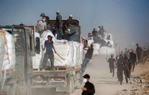 Palestinians carry aid parcels west of Beit Lahia in Gaza on July 29.