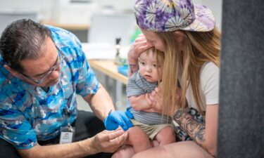 Raynard Covarrubio administers an MMR vaccine at a vaccine clinic in Lubbock
