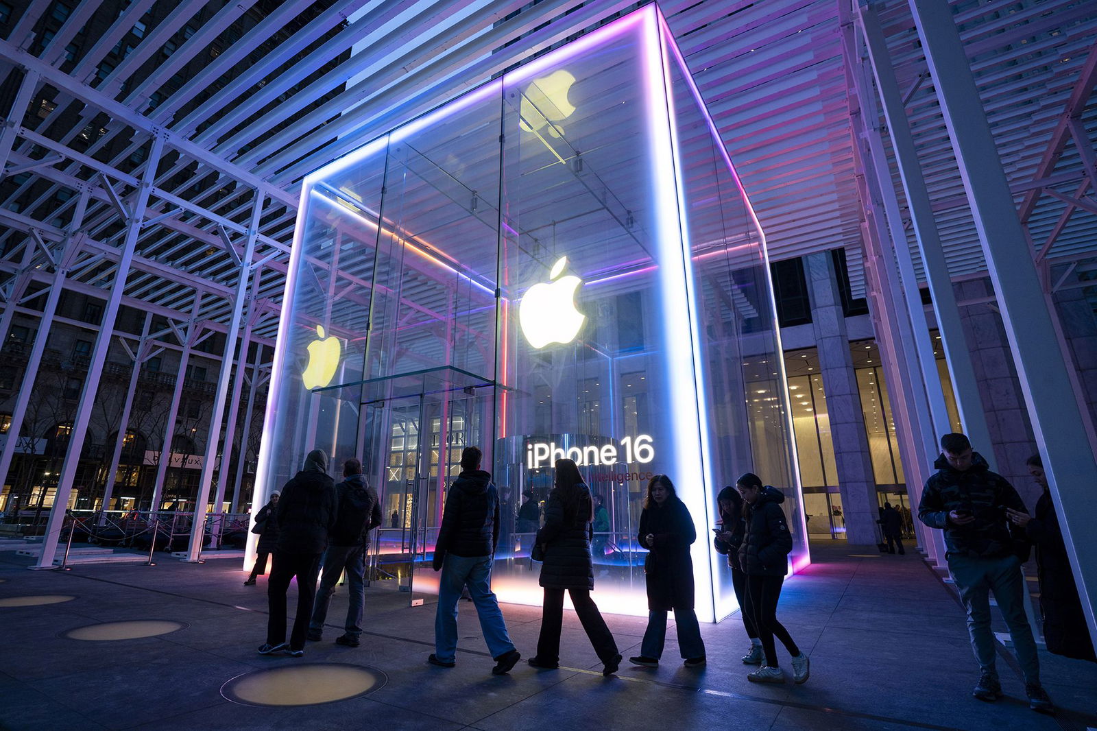 <i>Craig T Fruchtman/Getty Images via CNN Newsource</i><br/>People walk by the Apple Store on Fifth Avenue during sunset in New York City. Apple reported strong iPhone sales and rebound in revenue from China.