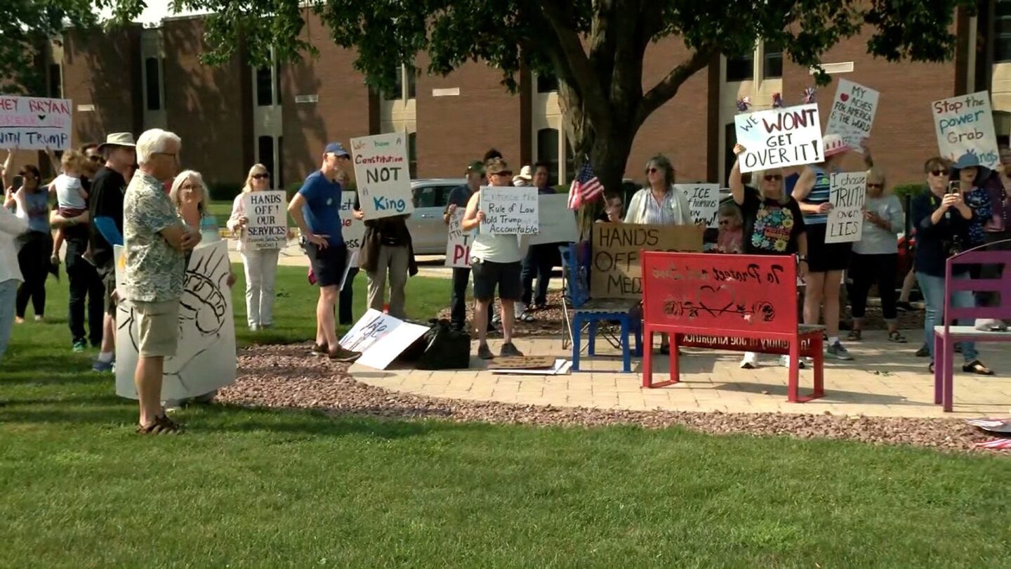 <i>WTMJ via CNN Newsource</i><br/>Protesters with signs gather outside the venue for Rep. Bryan Steil's town hall in Elkhorn