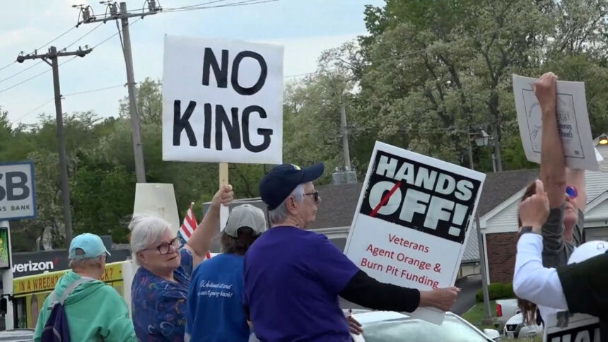 Protestors at Belt and Frederick waving 'No King' and "Hands Off' signs