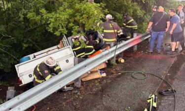 The driver was trapped inside the truck and needed to be extricated by rescue crews.