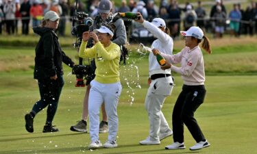 Yamashita is sprayed with champagne by fellow competitors after winning on August 3.