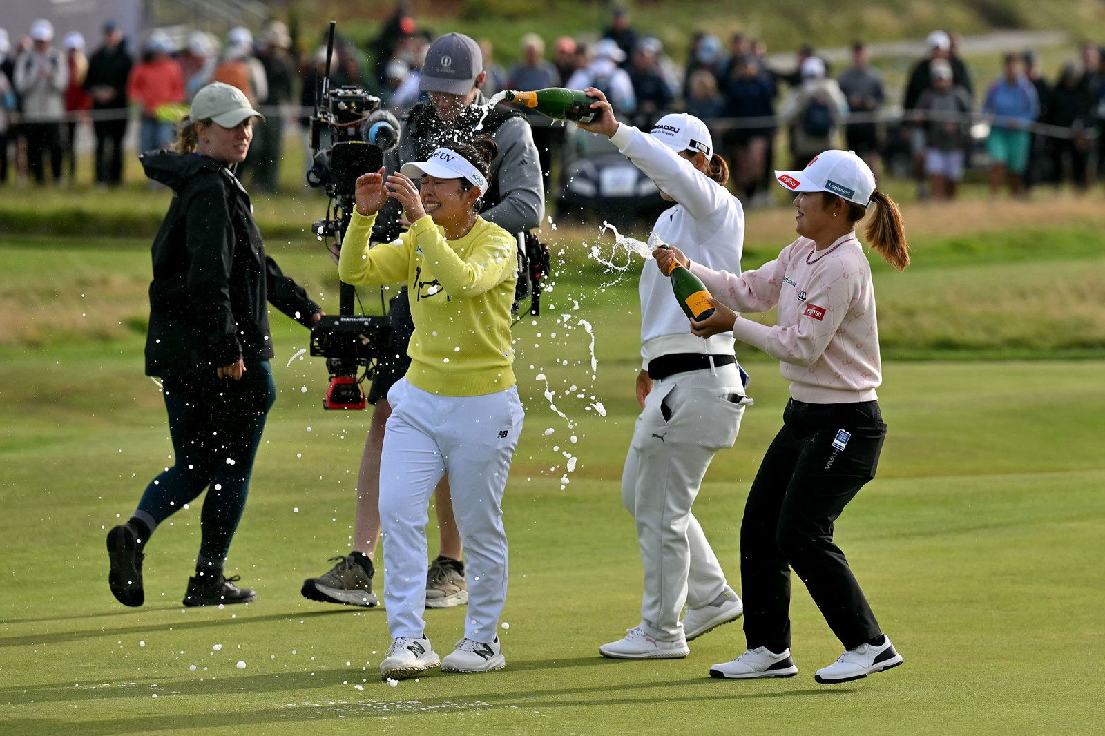 <i>Glyn Kirk/AFP/Getty Images via CNN Newsource</i><br/>Yamashita is sprayed with champagne by fellow competitors after winning on August 3.