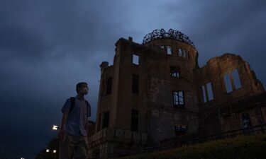 A visitor walks past the Atomic Bomb Dome in Hiroshima