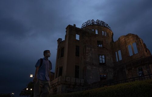 A visitor walks past the Atomic Bomb Dome in Hiroshima