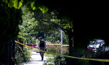 Police investigate the scene of a drive-by shooting in Chicago on July 6