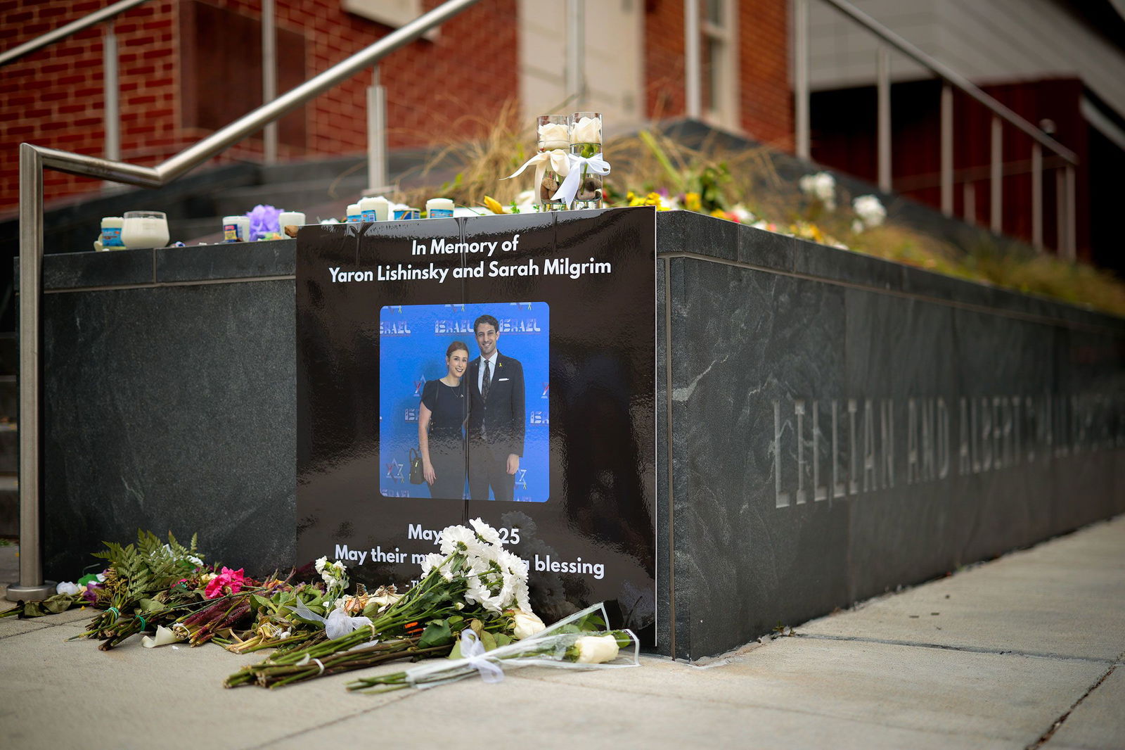 <i>Chip Somodevilla/Getty Images via CNN Newsource</i><br/>A photograph of Sarah Lynn Milgrim and Yaron Lischinsky is displayed outside the Lillian and Albert Small Capital Jewish Museum in Washington