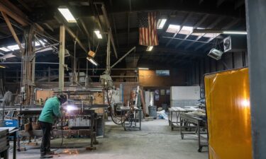 A worker arc welds a metal door during production at the Metal Manufacturing Co. facility in Sacramento