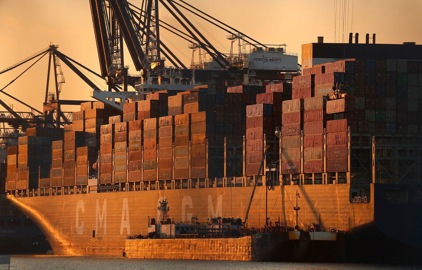 <i>Gary Hershorn/Corbis News/Getty Images via CNN Newsource</i><br/>A cargo ship is unloaded at Port Liberty in New Jersey. President Donald Trump's tariffs have brought in record levels of revenue.