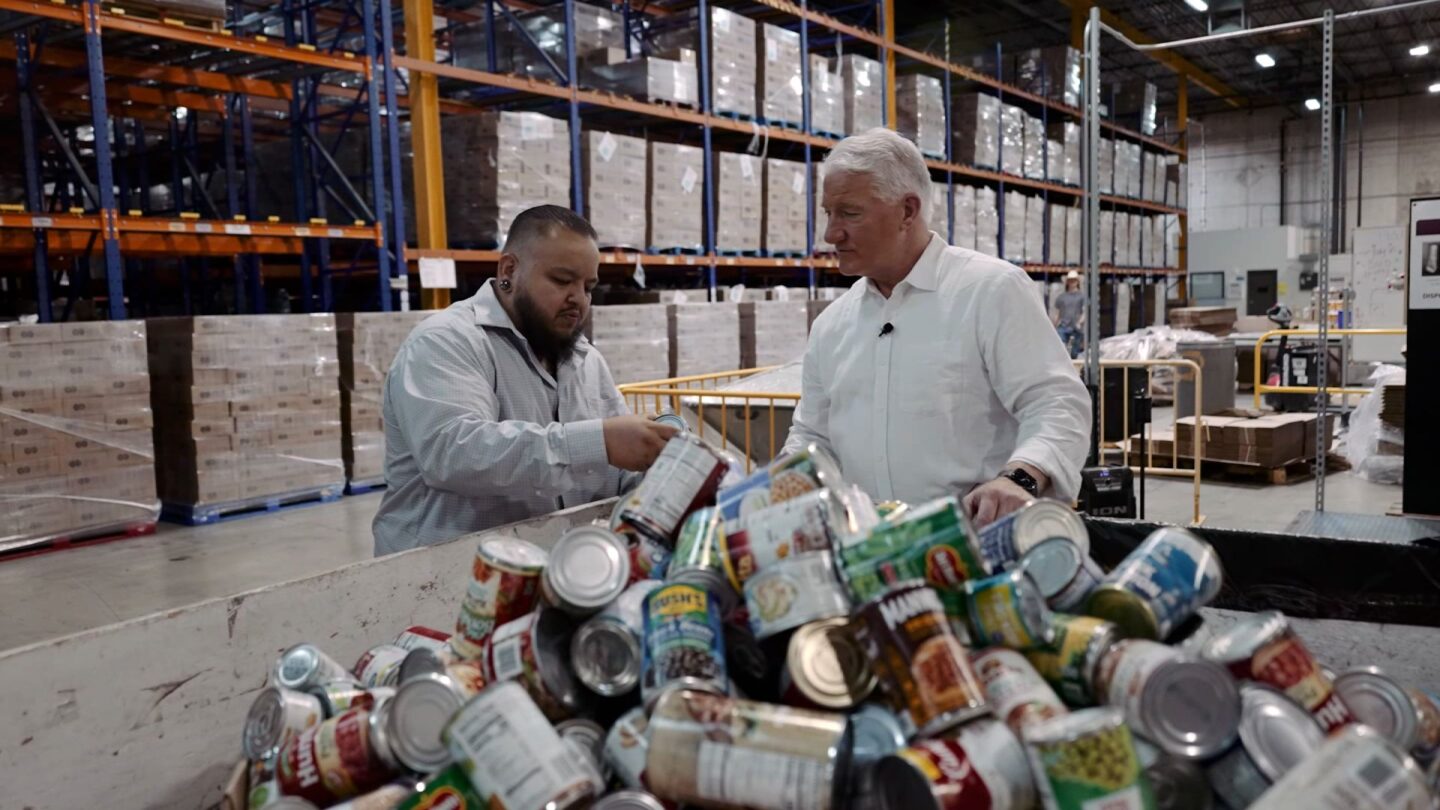 <i>CNN via CNN Newsource</i><br/>Volunteers work the supply line packing boxes of food at the Community Food Bank of Southern Arizona.