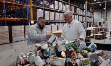 Volunteers work the supply line packing boxes of food at the Community Food Bank of Southern Arizona.