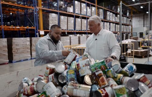 Volunteers work the supply line packing boxes of food at the Community Food Bank of Southern Arizona.