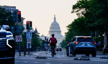 The US Capitol past commuters on Pennsylvania Avenue in Washington