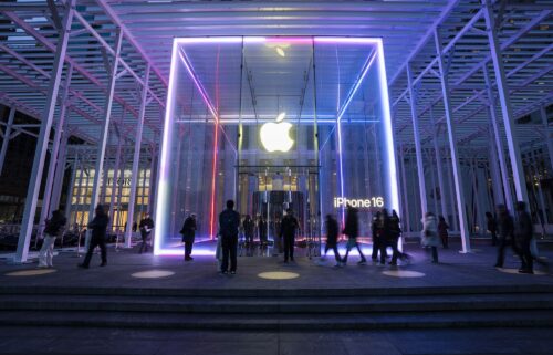 People walk by the Apple Store on Fifth Avenue on February 24 in New York City. Apple is investing another $100 billion to expand its operations in the United States