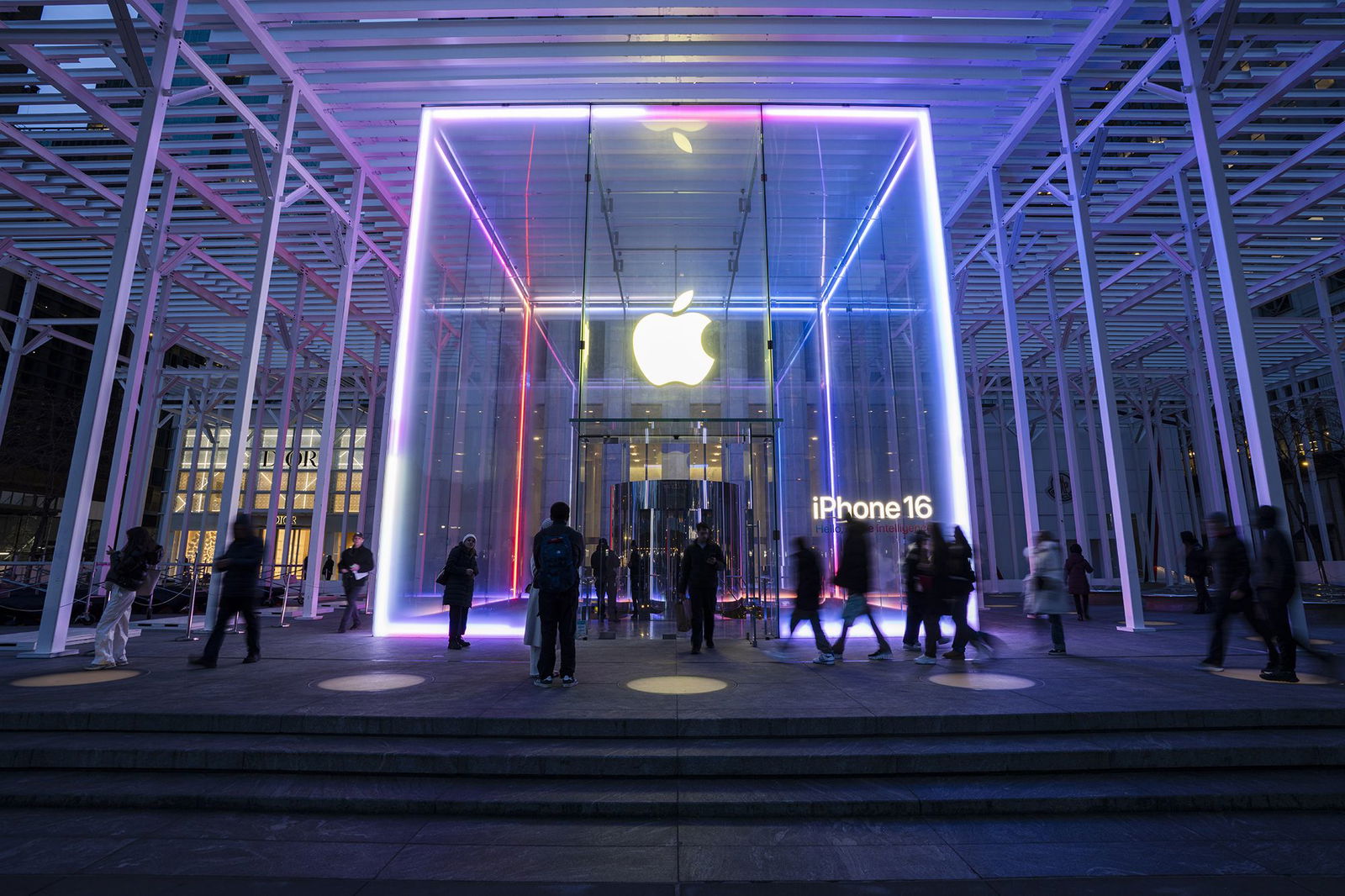 <i>Craig T Fruchtman/Getty Images via CNN Newsource</i><br/>People walk by the Apple Store on Fifth Avenue on February 24 in New York City. Apple is investing another $100 billion to expand its operations in the United States