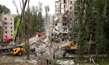 Rescue workers carry out a search and rescue operation at a destroyed residential building struck in a Russian drone-and-missile attack on July 31 in Kyiv