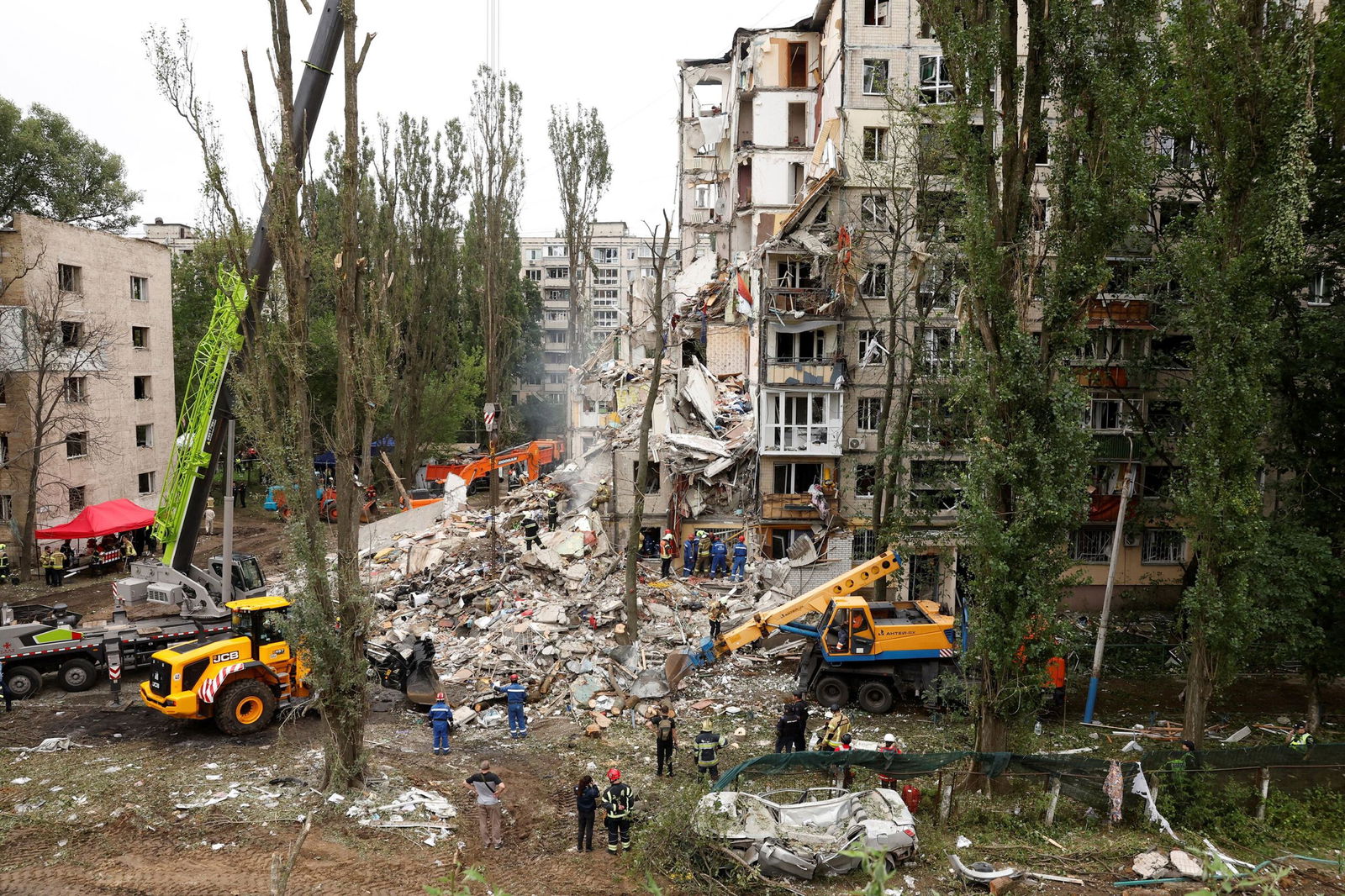 <i>Yevhenii Zavhorodnii/Global Images Ukraine/Getty Images via CNN Newsource</i><br/>Rescue workers carry out a search and rescue operation at a destroyed residential building struck in a Russian drone-and-missile attack on July 31 in Kyiv