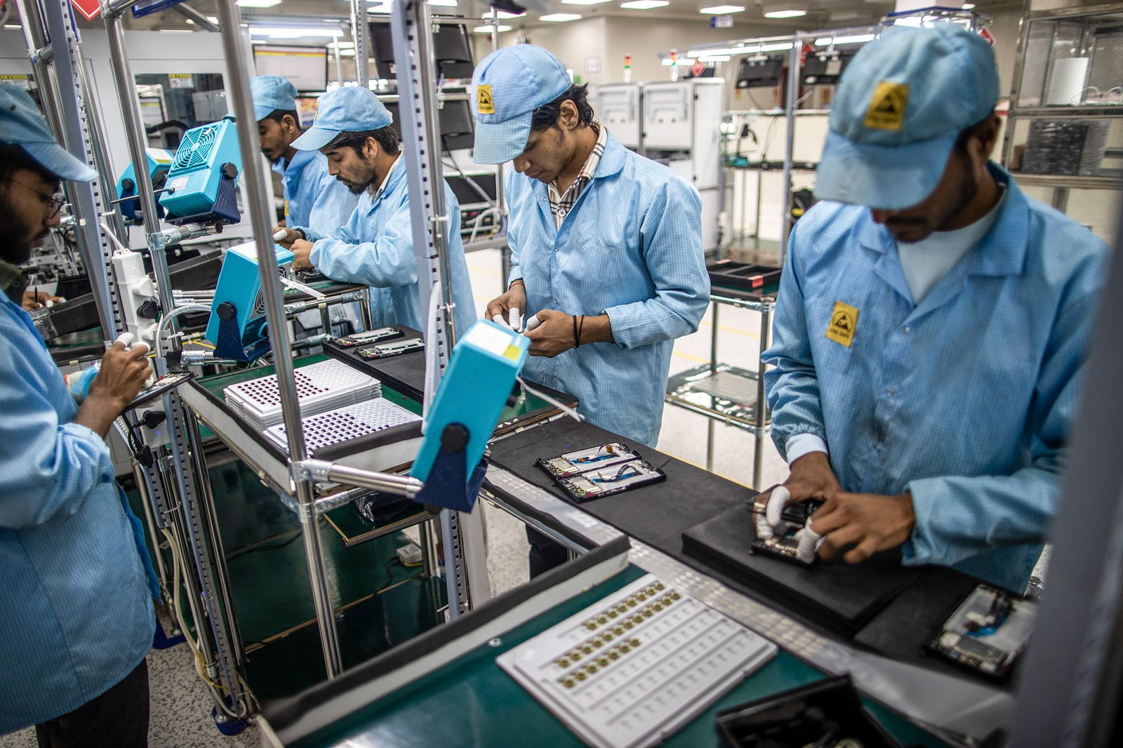 <i>Prashanth Vishwanathan/Bloomberg/Getty Images via CNN Newsource</i><br/>Employees work on a mobile phone assembly line in Noida