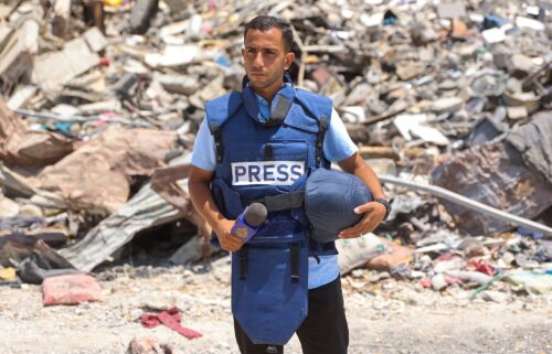 Palestinians stand near the destroyed Al Jazeera tent at Al-Shifa Hospital in Gaza City on August 11
