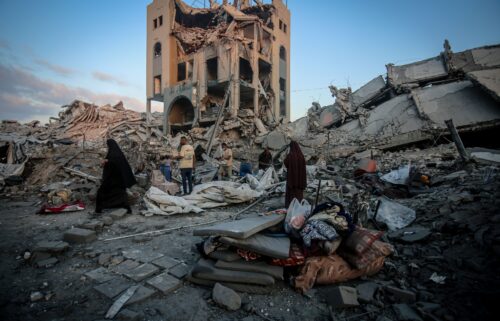Palestinians make their way through the aftermath of an Israeli strike in the Sheikh Ridwan neighborhood of Gaza City