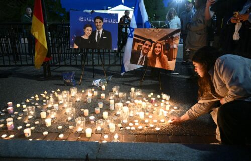 People attend a candlelight vigil at Lafayette Square across from the White House in Washington