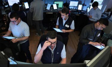 Traders work on the floor of the New York Stock Exchange during afternoon trading on August 1