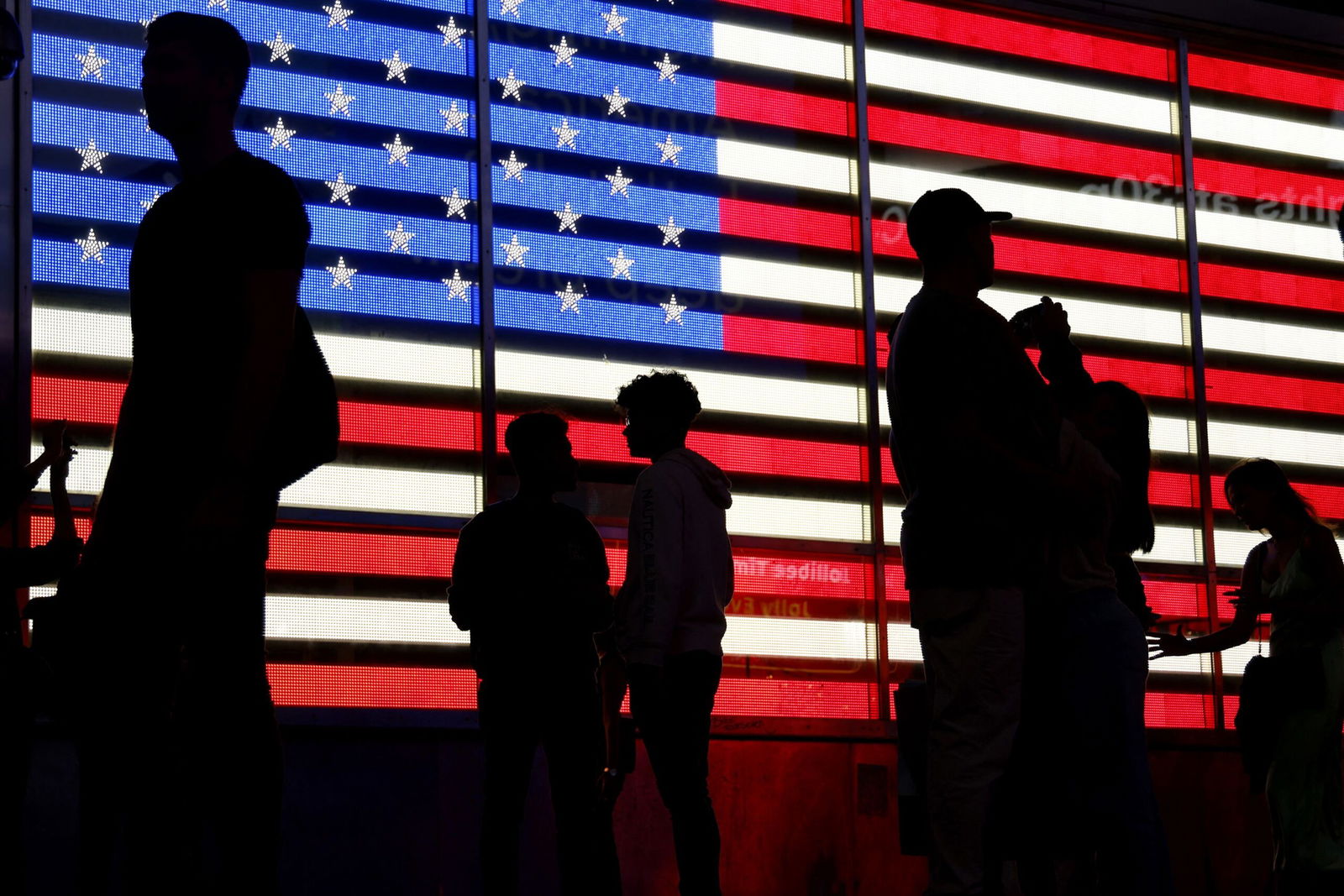 <i>Ludovic Marin/AFP/Getty Images via CNN Newsource</i><br/>People stand in front of a US flag on a screen in Times Square in New York on September 19