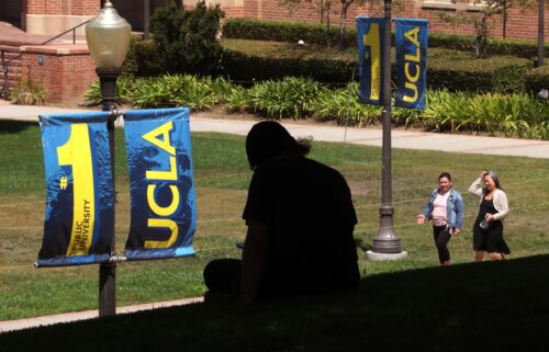 A student rests in the shade on the UCLA campus in Los Angeles on August 7.