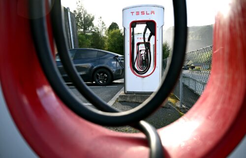 Tesla electric cars are stationed in a storage area in the Zeebrugge port