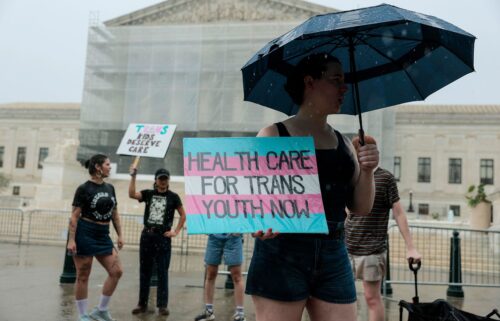A protester holds a sign in support of gender-affirming care for transgender youth outside of the U.S. Supreme Court Building on June 18 in Washington
