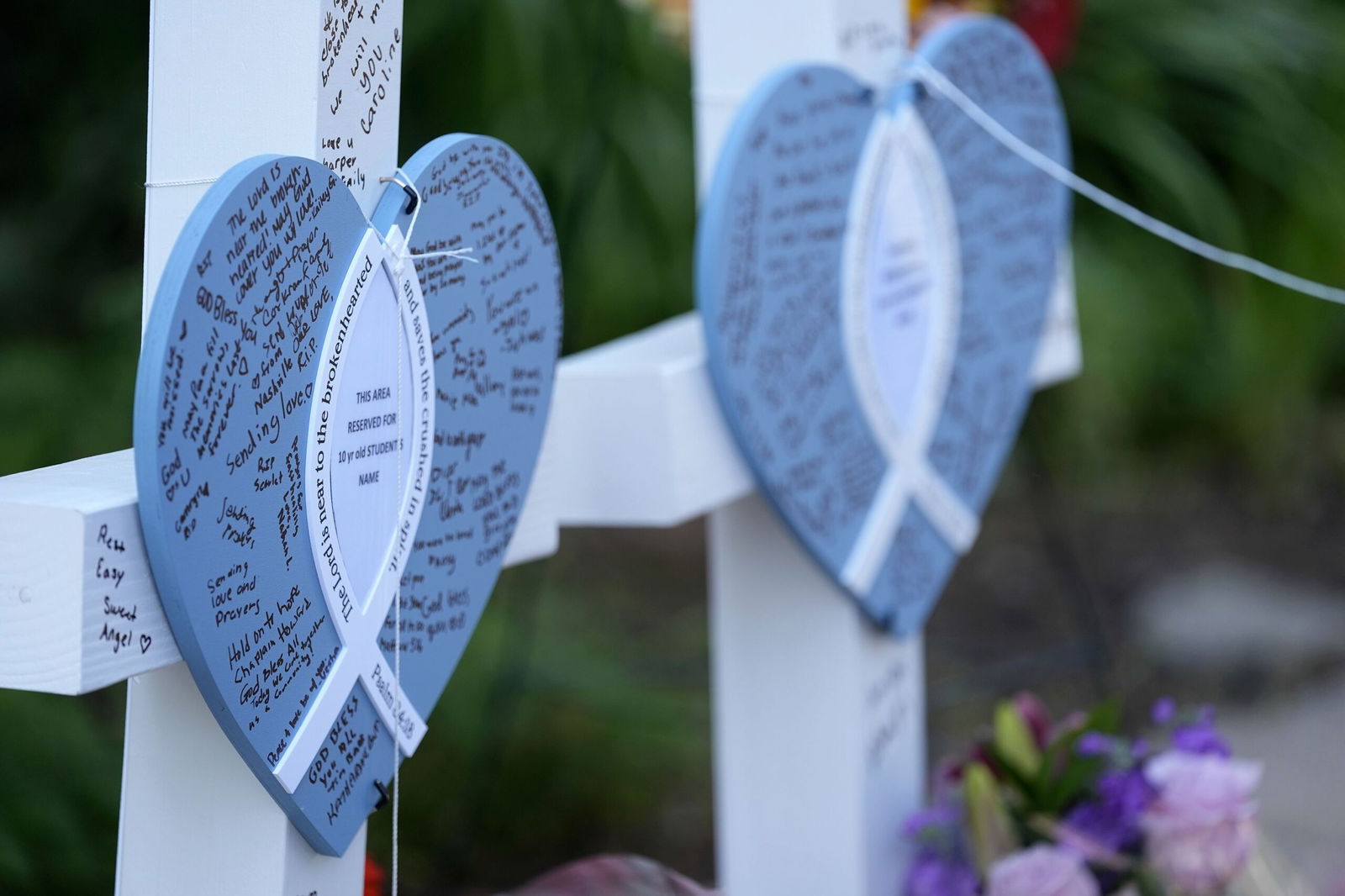 <i>Abbie Parr/AP via CNN Newsource</i><br/>Written messages are left on hearts at a makeshift memorial at Annunciation Catholic Church and School in Minneapolis on Thursday.