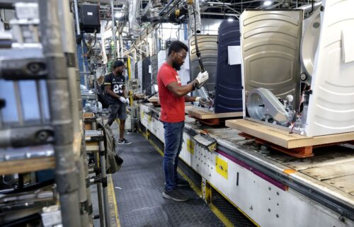 Workers are seen on the production line at GE Appliances on August 13 in Louisville