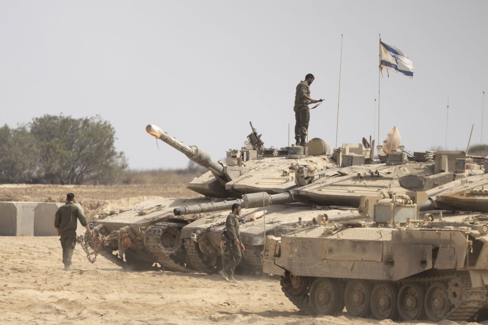 <i>Amir Levy/Getty Images via CNN Newsource</i><br/>Israeli soldiers work near tanks in a gathering point near the border with the Gaza Strip