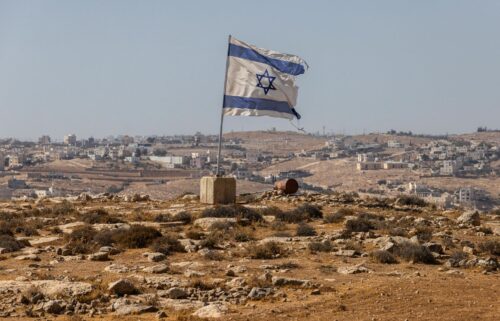 An Israeli flag flies along a highway near the settlement of Carmel in the South Hebron Hills of the West Bank on August 4.