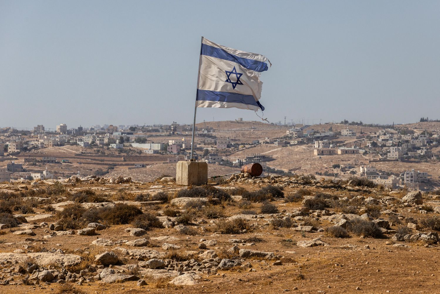 <i>Tamir Kalifa/Getty Images via CNN Newsource</i><br/>An Israeli flag flies along a highway near the settlement of Carmel in the South Hebron Hills of the West Bank on August 4.