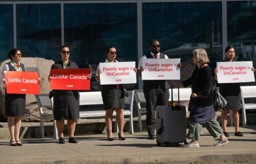 Air Canada flight attendants standing in a silent protest at Vancouver International Airport.