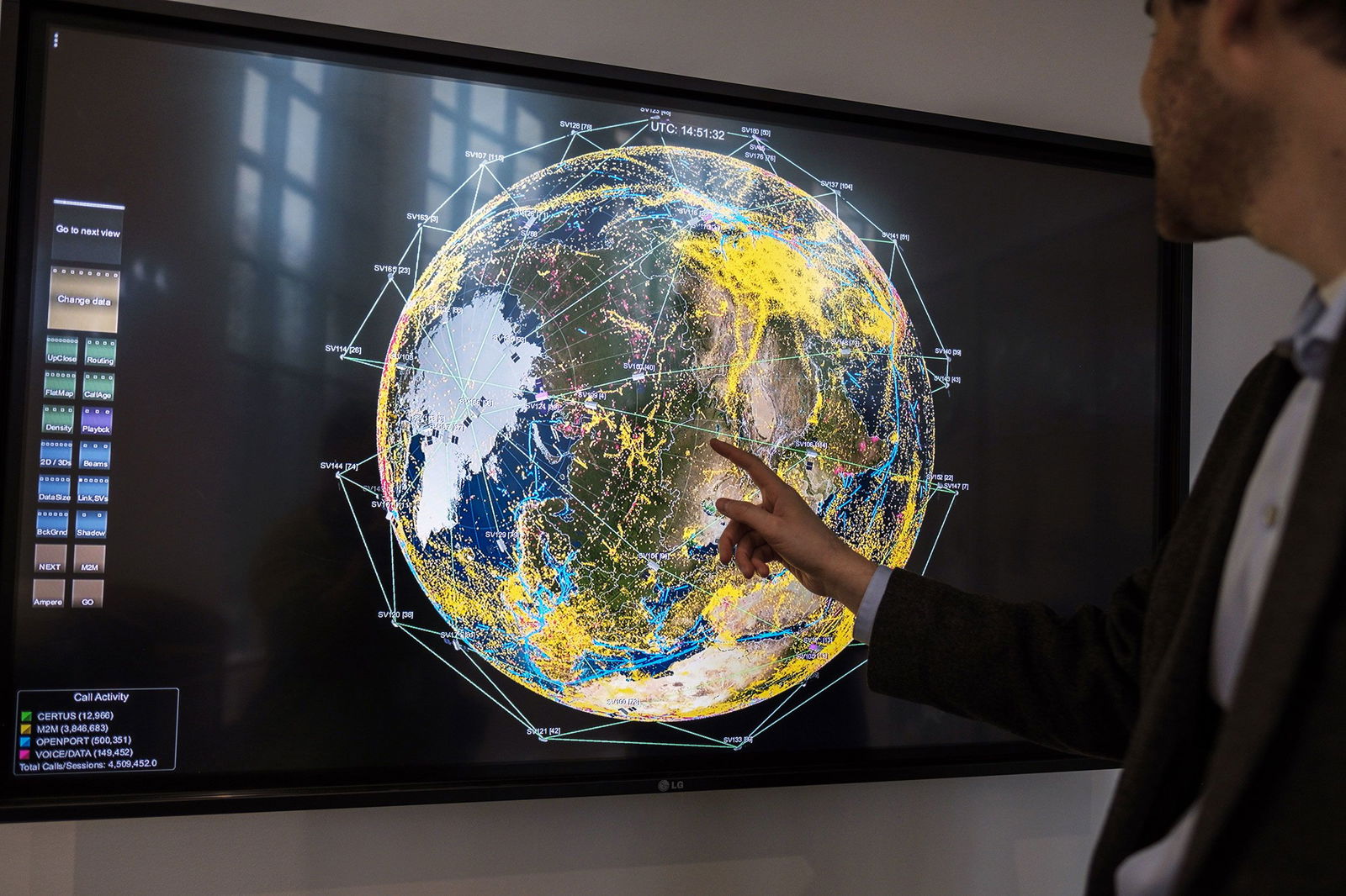 <i>Justin Ide/Bloomberg/Getty Images via CNN Newsource</i><br/>A worker points to a monitor displaying current satellites in orbit and real-time communications across the globe at the Iridium Communications Inc. Satellite Network Operations Center in Leesburg