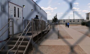 Immigrants walk through the ICE South Texas Family Residential Center