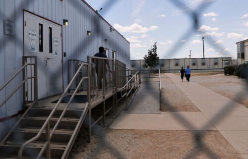 Immigrants walk through the ICE South Texas Family Residential Center
