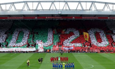 A memorial filled with flowers sits outside Anfield.